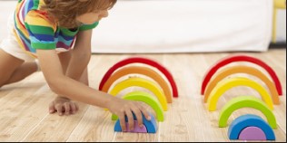 NovoBam set of wooden rainbow-colored stacking and nesting puzzle blocks, suitable for kids of all ages. The blocks vary in size and can be arranged to form different patterns and shapes. The set helps develop children's fine motor skills, spatial awareness, and creativity. The wooden blocks are eco-friendly and durable, making them a long-lasting and sustainable toy option for kids