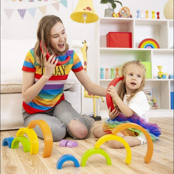 NovoBam set of wooden rainbow-colored stacking and nesting puzzle blocks, suitable for kids of all ages. The blocks vary in size and can be arranged to form different patterns and shapes. The set helps develop children's fine motor skills, spatial awareness, and creativity. The wooden blocks are eco-friendly and durable, making them a long-lasting and sustainable toy option for kids