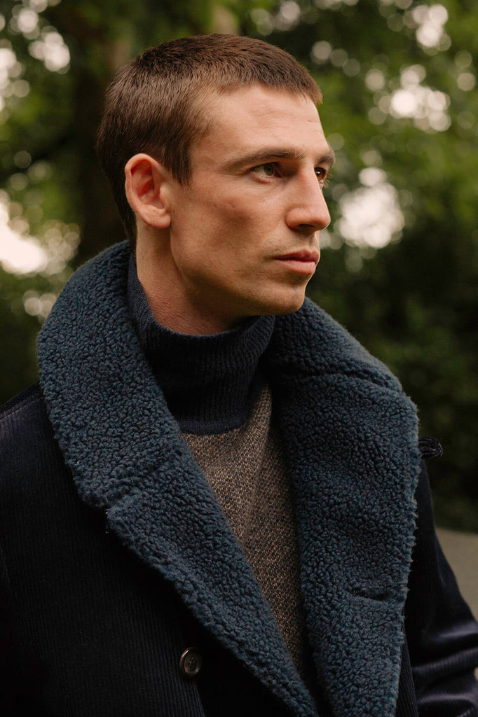 A model wearing the navy Newington coat by Oliver Spencer.