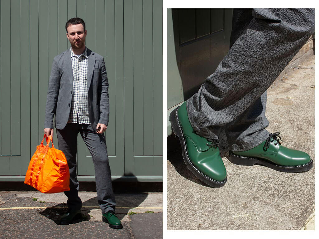 ALFIE IS WEARING THEOBALD JACKET COBHAM CHARCOAL, DRAWSTRING TROUSERS COBHAM CHARCOAL, HAWAIIAN SHORT SLEEVE SHIRT EBLEY GREEN, SOLOVAIR GREEN HI-SHINE GIBSON SHOES