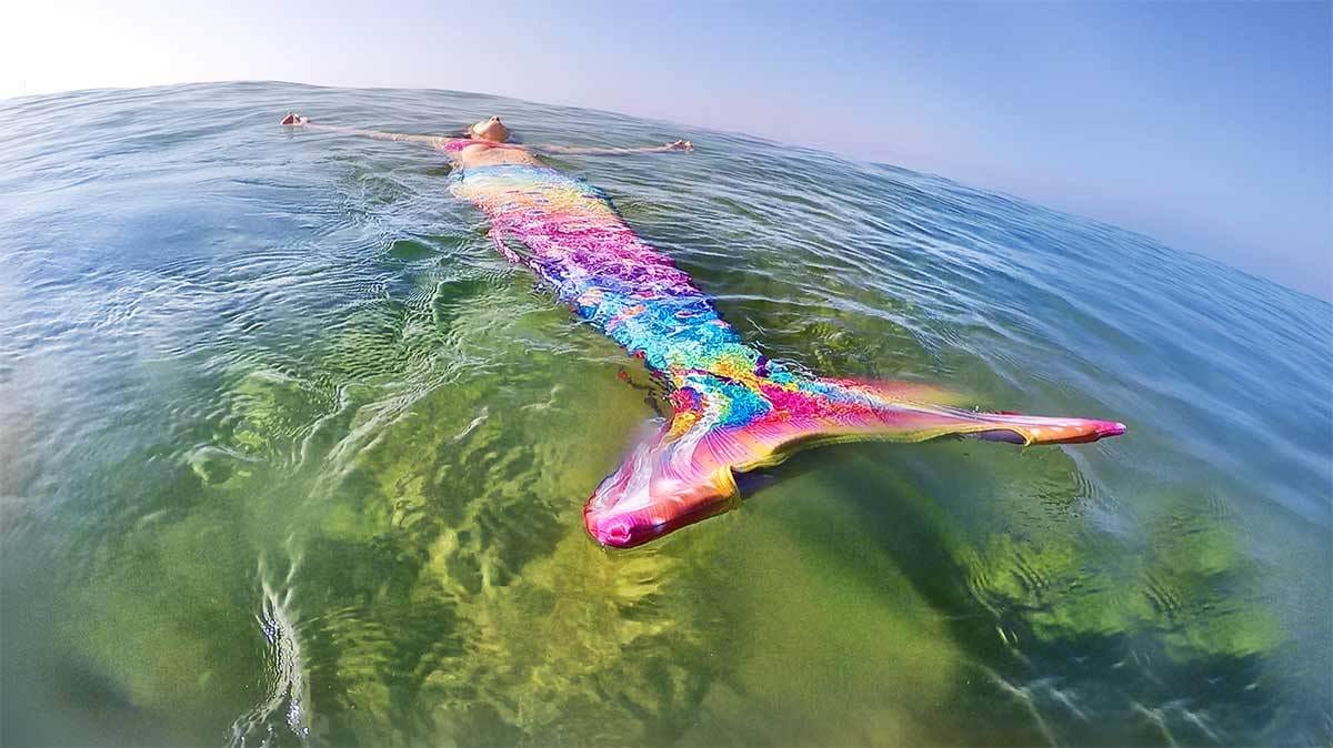 Mermaid having fin fun while afloat in water