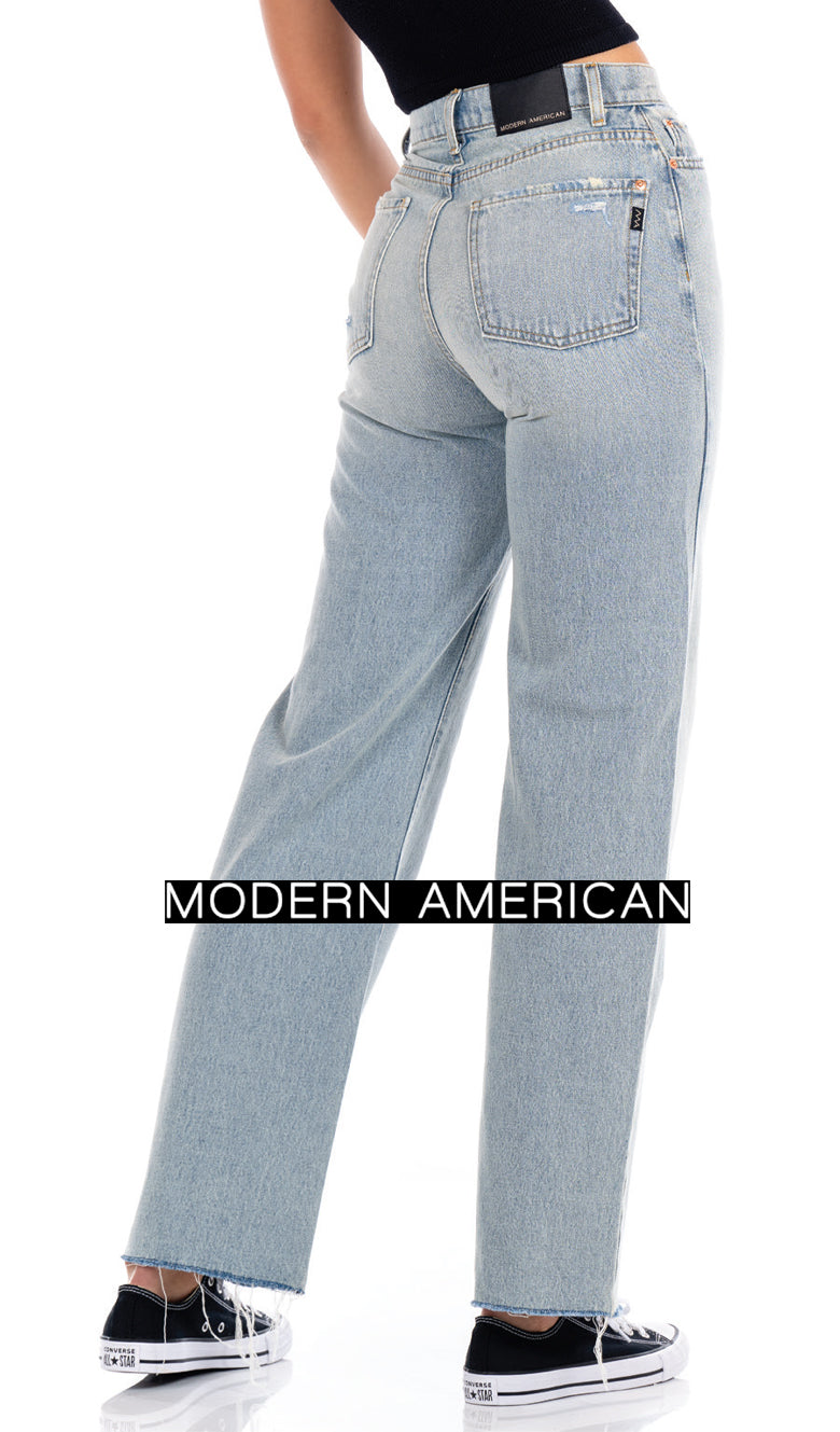 Woman from back in faded light blue jeans