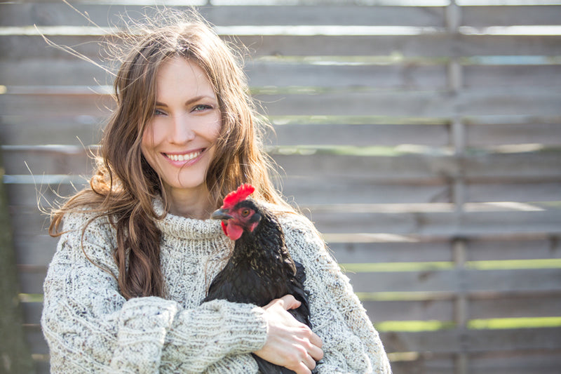 Woman raising backyard chickens