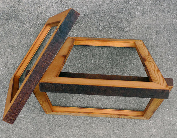 a pile of wooden art frames