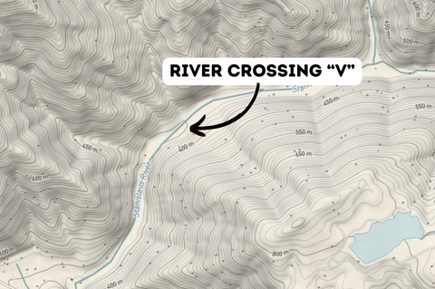 Contour lines crossing a river within a topographic map.
