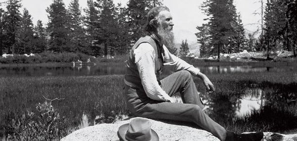 Famous John Muir sitting by a lake