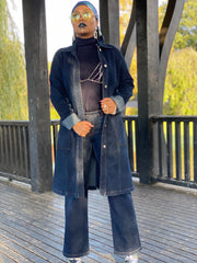 Outfit shot of person wearing denim jacket and jeans facing camera