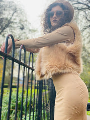 Portrait photo of person wearing rented golden caramel furry waist coat facing left side