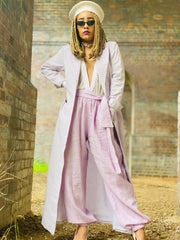 Outfit shot of person wearing lilac trousers and jacket facing camera