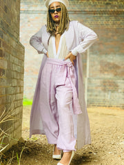 Outfit shot of person wearing lilac trousers and jacket facing camera