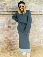Outfit shot of person wearing grey jumper and matching skirt facing camera