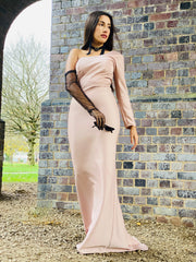 Outfit shot of person wearing long pink gown and black glove facing camera