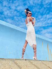 Outfit shot of person wearing white dress posing turning away from the camera