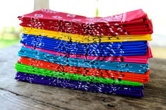 Image of stack of multi-coloured bandanas