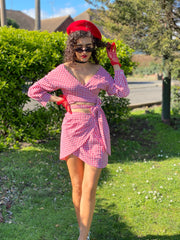 Outfit shot of person wearing matching pink plaid wrap co-ord facing camera