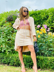 Outfit shot of person wearing matching mini skirt and blazer facing camera standing