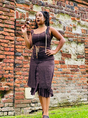 Outfit shot of person wearing rented brown skirt and lace up top facing camera