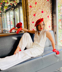 Outfit shot of person wearing white trousers and blouse