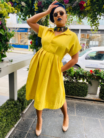 Portrait photograph of woman wearing rented Daffodil Flax Dress | One Wear Freedom