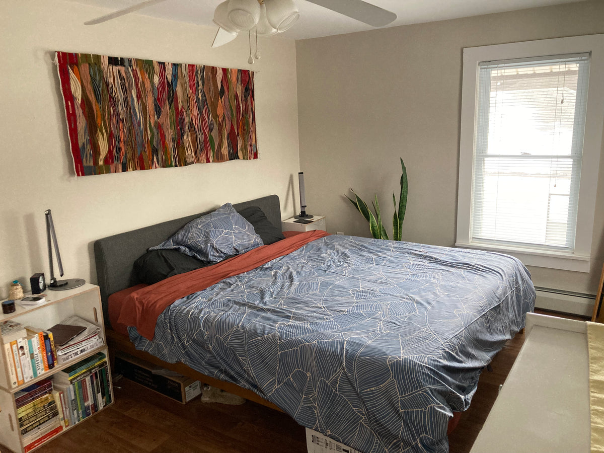 Colorful red Moroccan flatweave kilim hung above bed