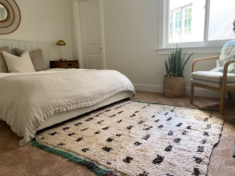 Neutral Moroccan rug in a boho chic bedroom