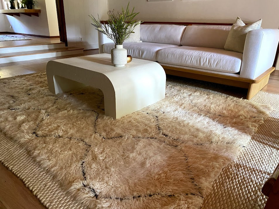 Minimalist boho chic living room featuring a plush white Beni Ourain Moroccan rug