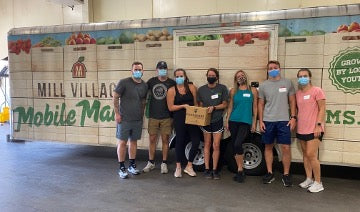 Jack and other LifeMade employees volunteering at Mill Village Farms
