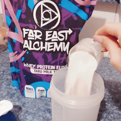 boomerang of one scoop of far east alchemy taro milk tea protein powder in a shaker