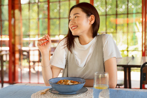 smiling woman eating tasty food