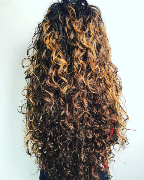 woman with curly hair facing away