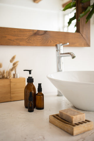 amber glass bottles sitting beside a sink