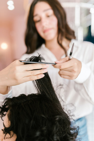 stylist cutting curly hair