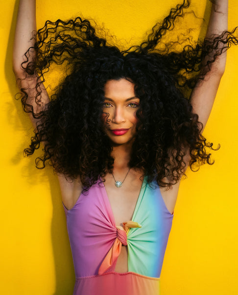 woman with curly hair and colourful top