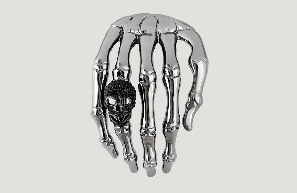 Large skeleton hand with skull shoulder brooch