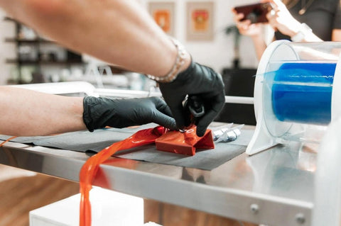 A cosmetic tattoo technician is preparing their cosmetic tattoo supplies for a procedure