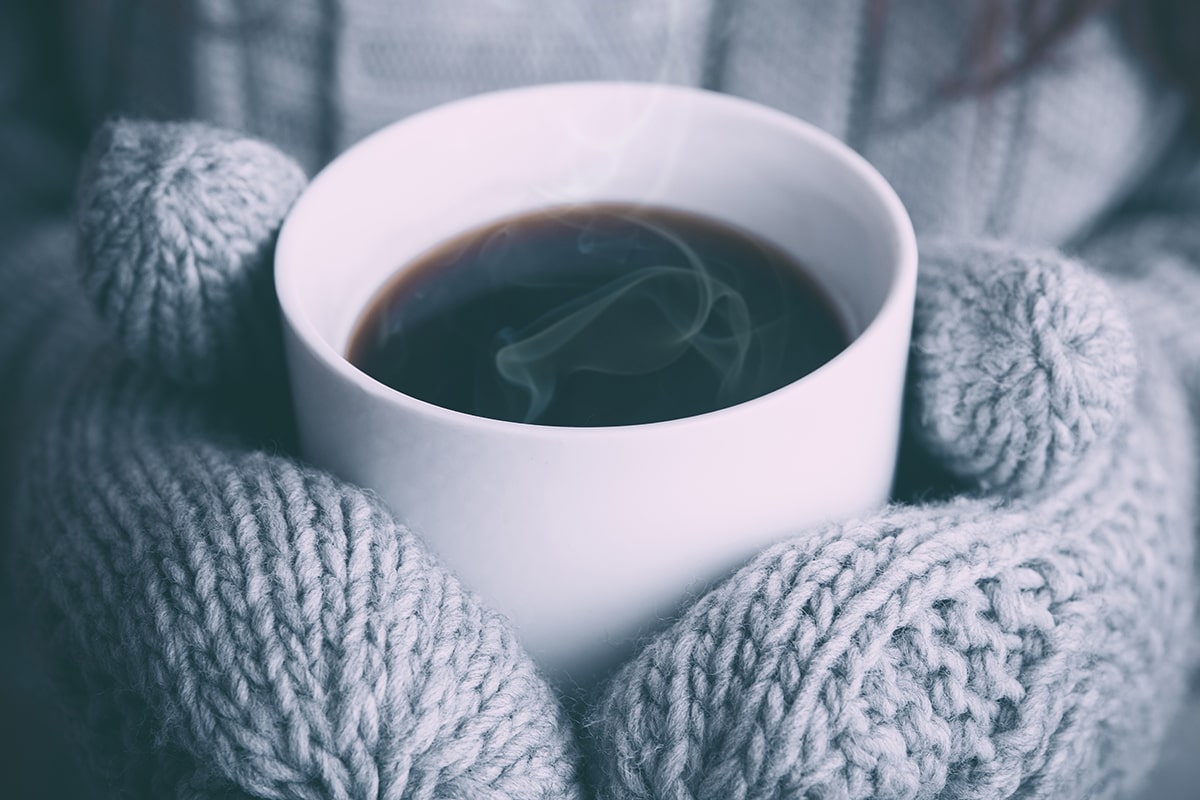 Cosy image of person holding tea