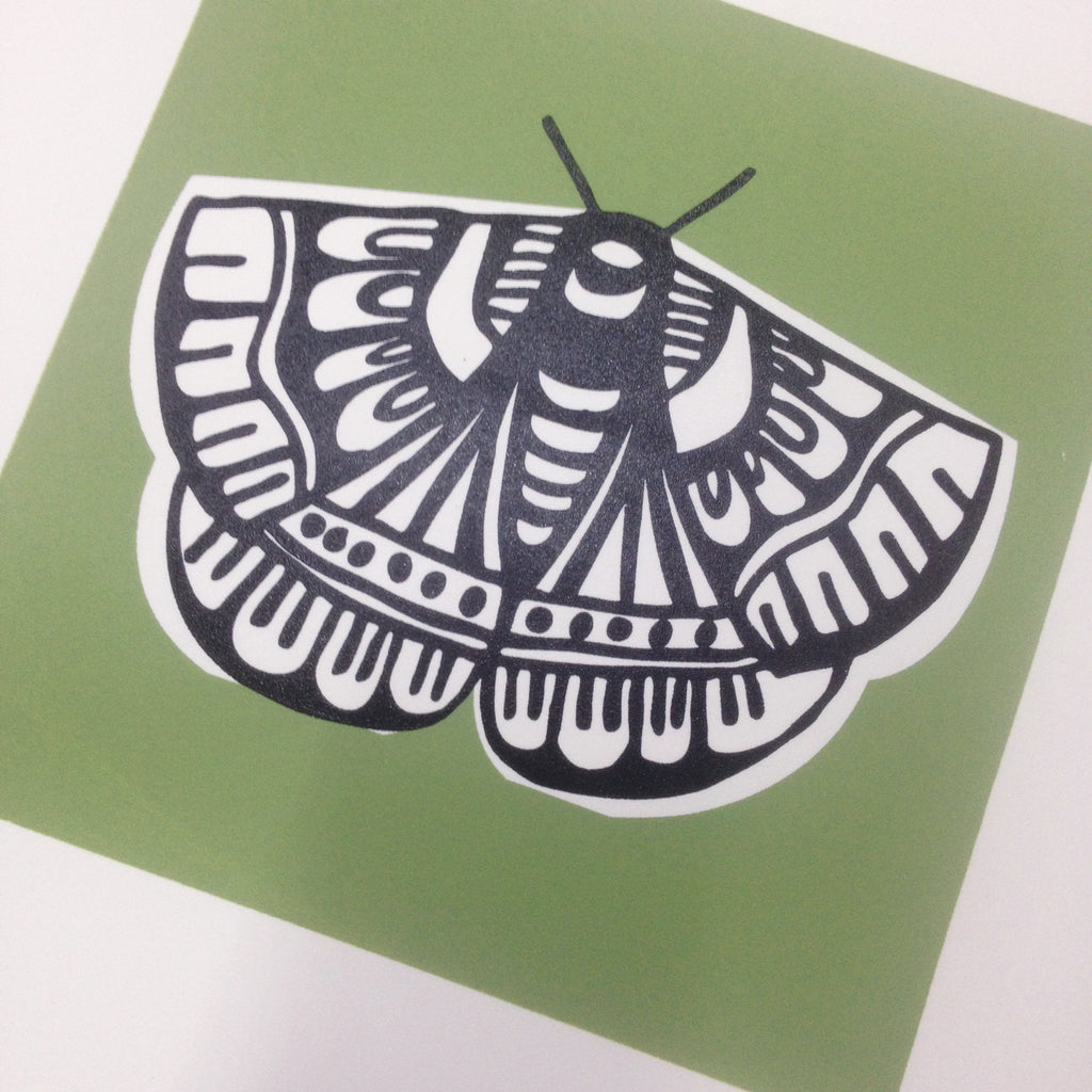 Close up of a freshly screen printed Butterfly in Sage Green. 