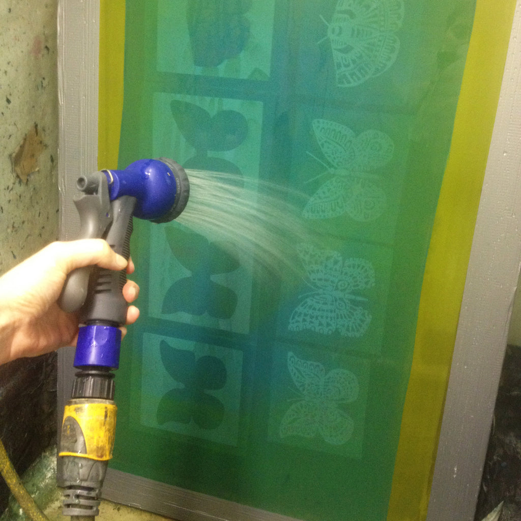In the exposure process for screen printing, the screen is washed out to reveal the design to be printed by hand.