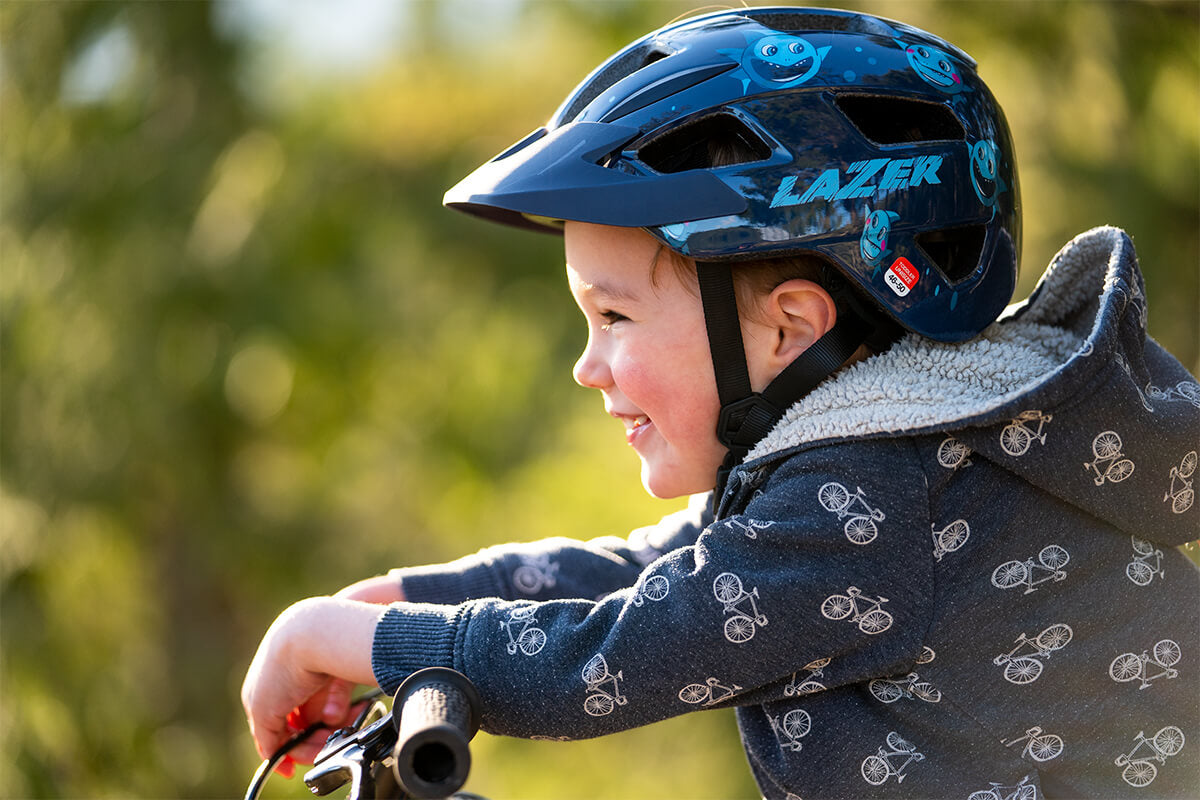 Young boy riding his bike wearing a Lazer Lil' Gekko MIPS kids bike helmet