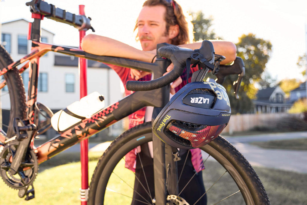 Peter Stetina standing with his bike and Lazer Vento KientiCore bicycle helmet at big sugar gravel bike race