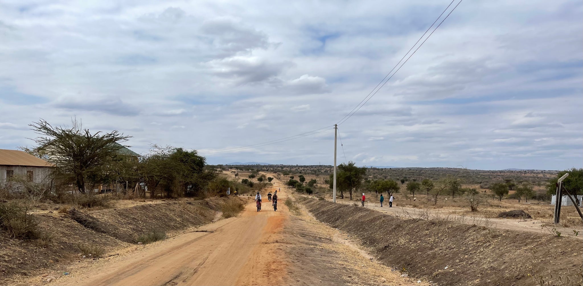 Crystal Kovac riding her bicycle across kenya wearing a Lazer road bike helmet