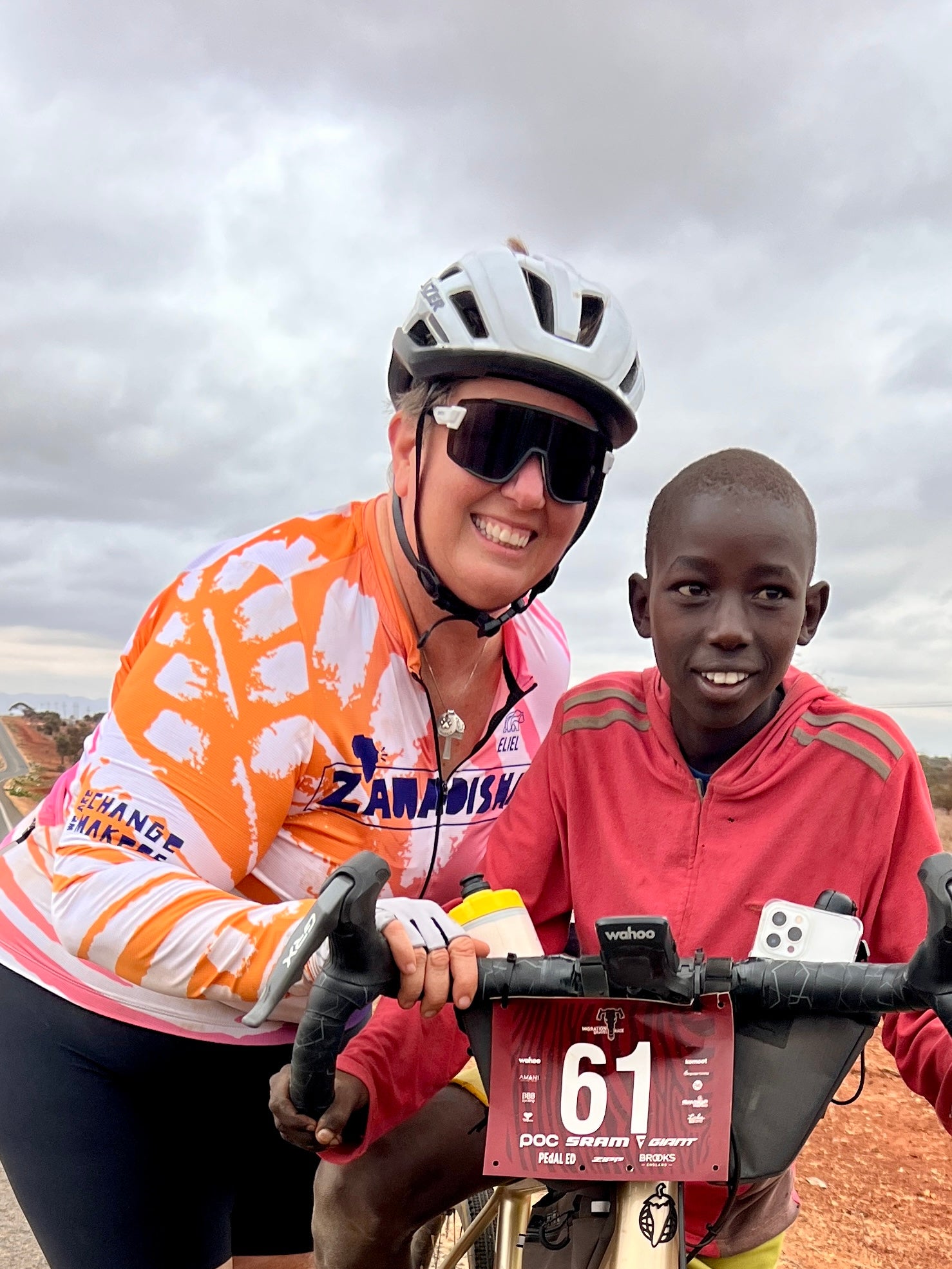 Crystal Kovac riding her gravel bike in Kenya wearing a Lazer Strada KinetiCore bike helmet