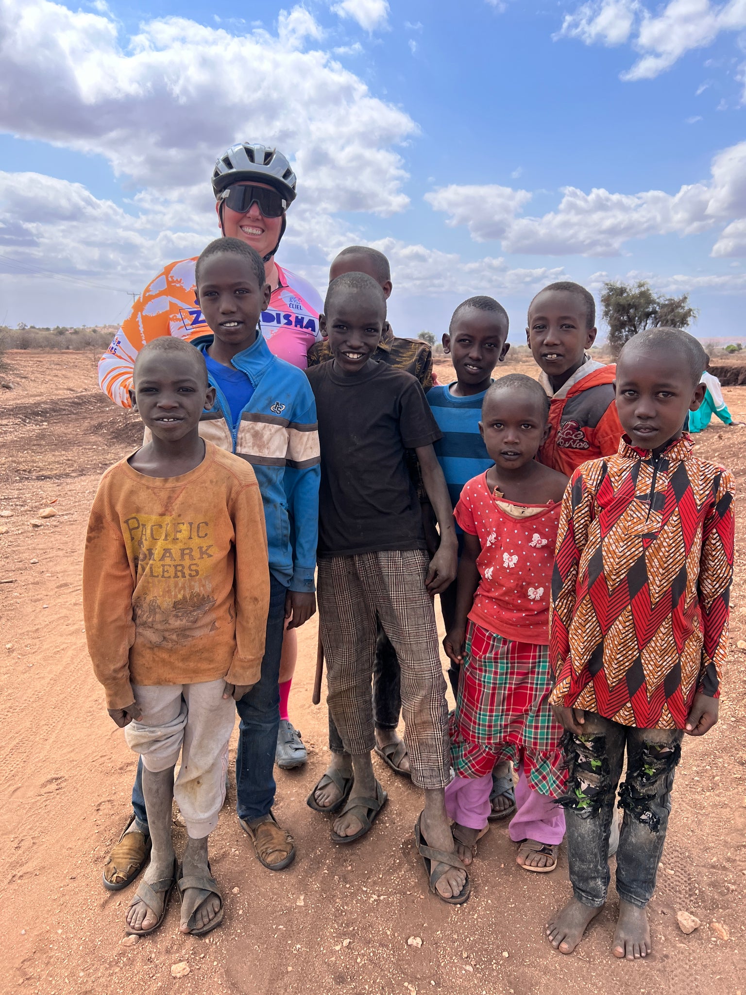 Crystak riding her gravel bike across Kenya wearing a Lazer Strada KinetiCore road bike helmet