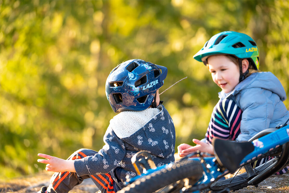 Kids riding their bikes wearing a Lazer Gekko MIPS and Lazer Lil' Gekko MIPS bicycle helmets