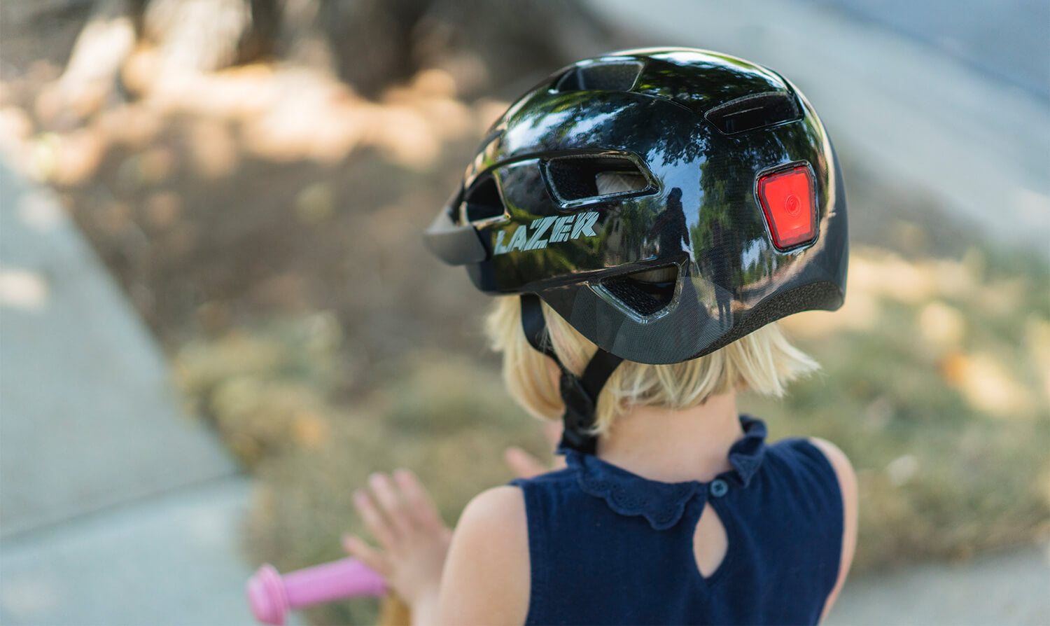Young Girl wearing a Black Lazer Gekko MIPS Kids Helmet with Lazer Gekko LEd taillight 