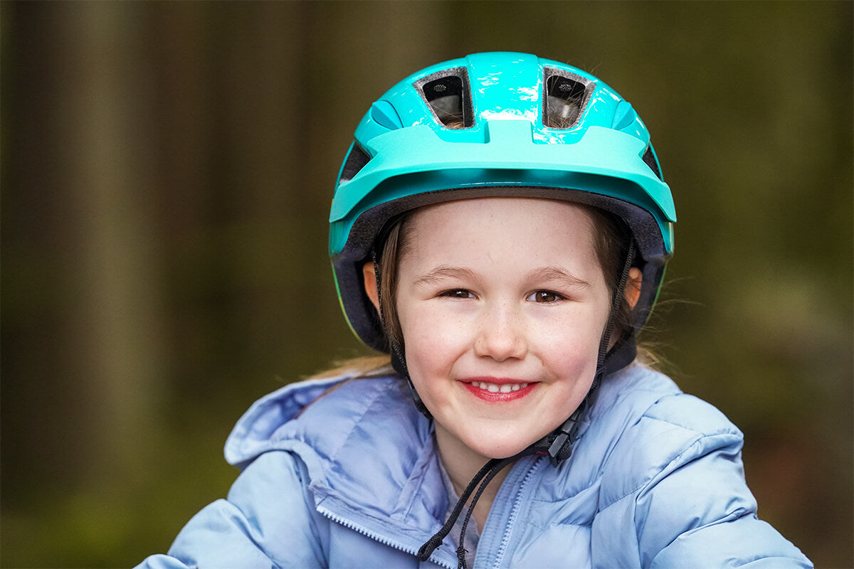 Young Girl riding her bike wearing a Lazer Gekko MIPS kids bicycle helmet