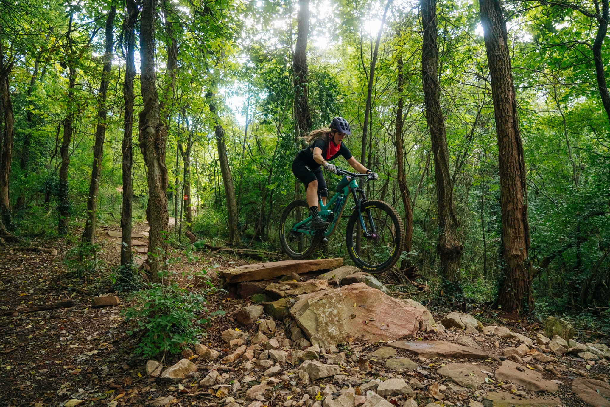 Women mountain biking wearing a Lazer helmet