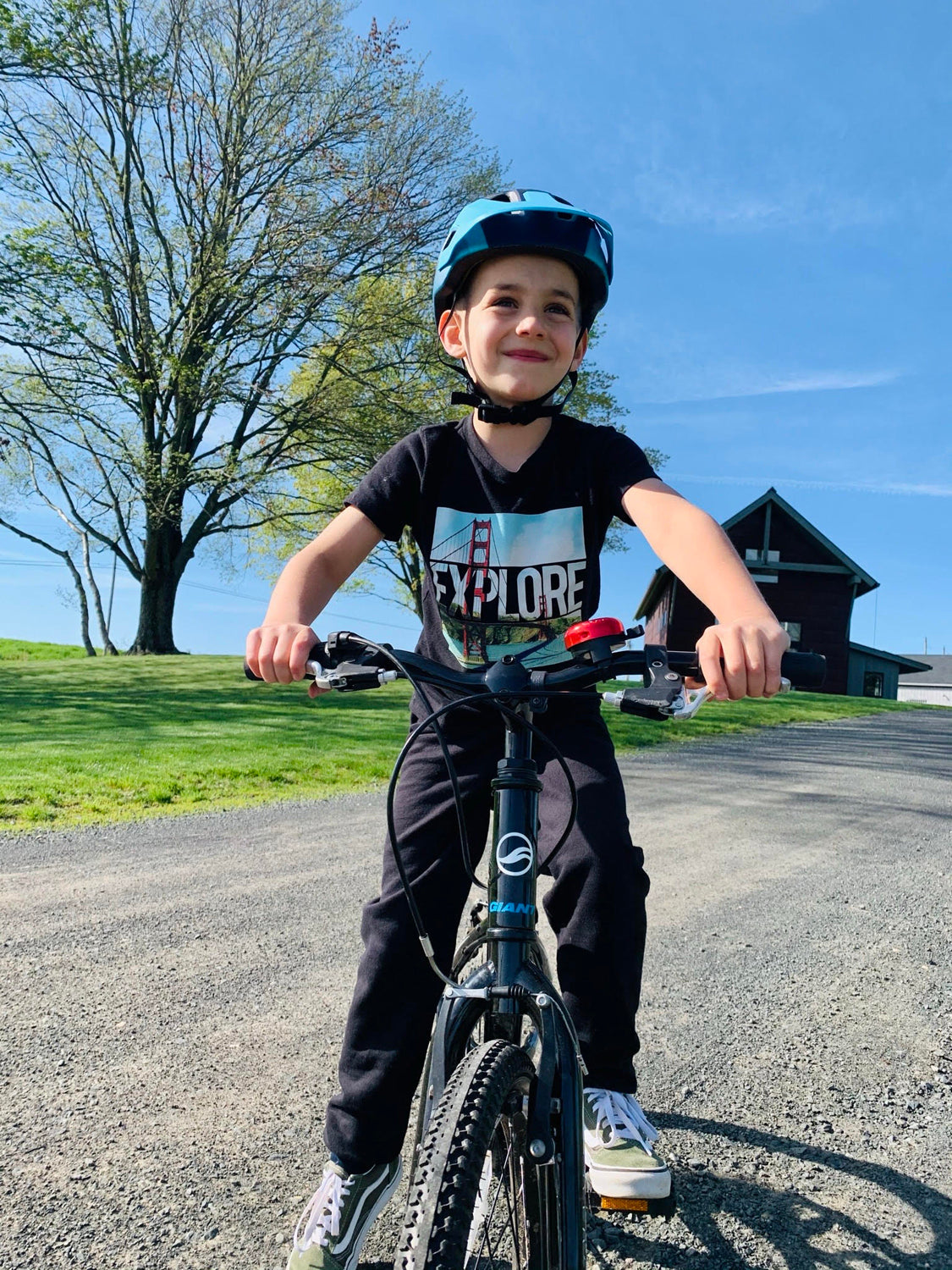 Young Kid riding his bike with a Lazer bike helmet