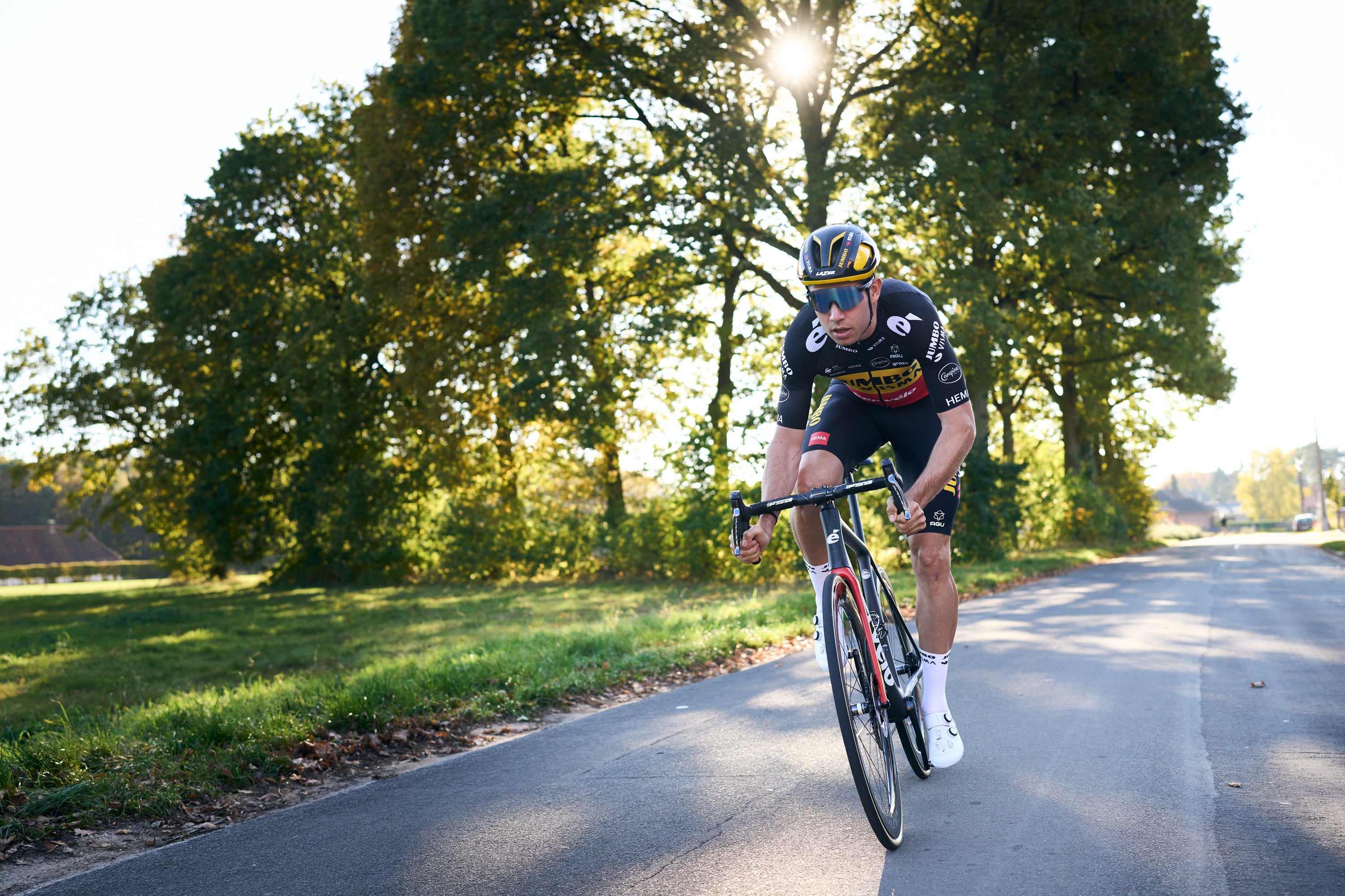 Pro team rider Wout van Aert riding his road bike wearing a Lazer Vento KinetiCore bik helmet