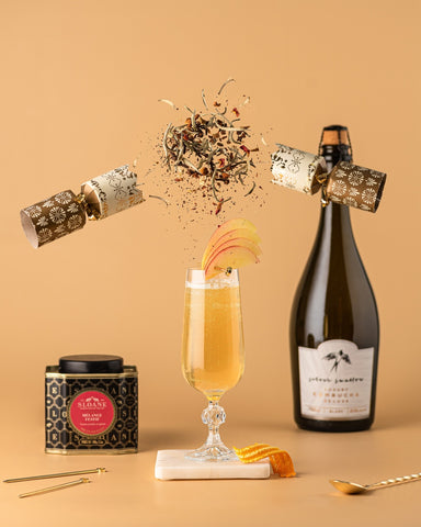 Sparkling Spice Cocktail with Sloane Celebration and Silver Swallow Tea exploding out of a holiday cracker